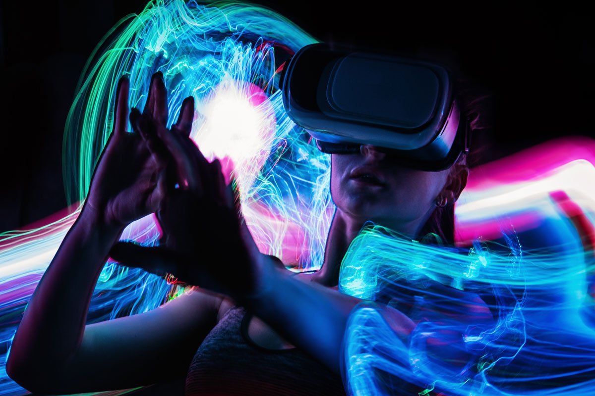 Person wearing a VR headset interacting with a vibrant, colorful light display. | Forensic Discovery