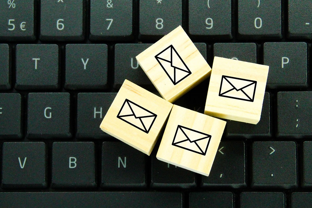 Four wooden blocks with email symbols on a keyboard. | Forensic Discovery