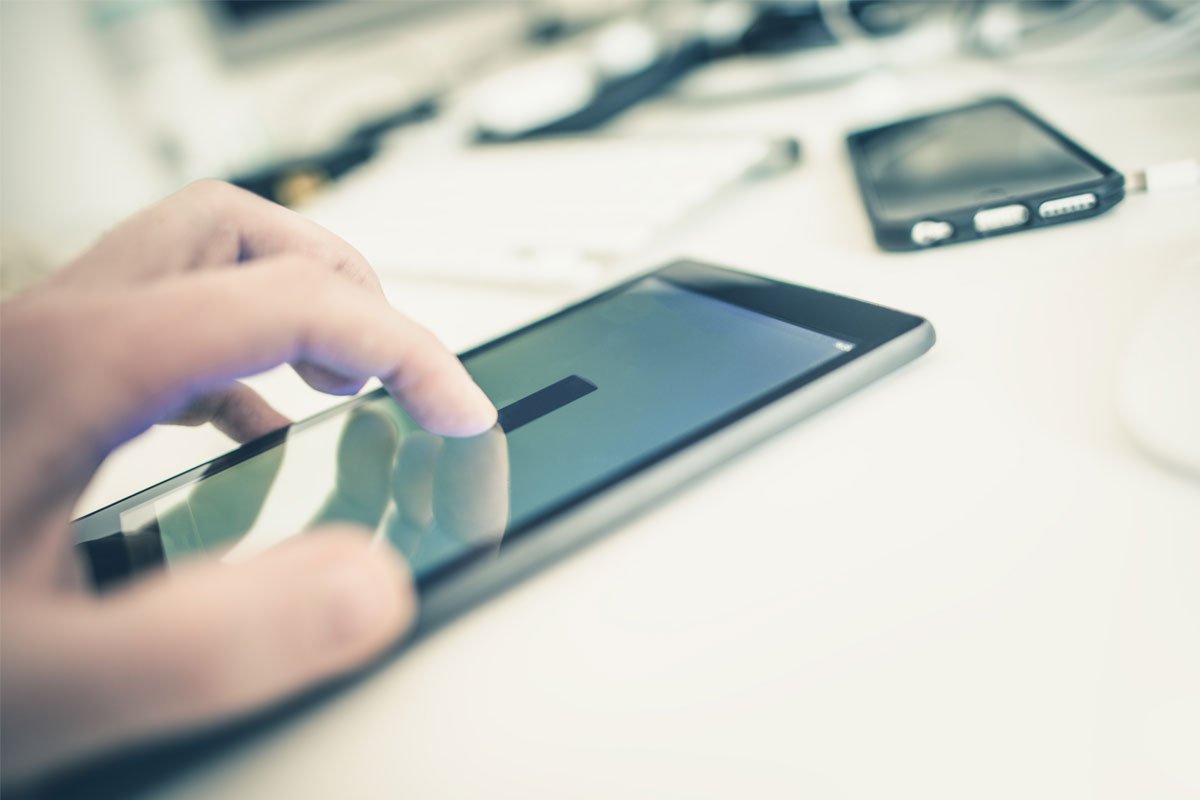 Close-up of a person's hand using a tablet. | Forensic Discovery